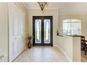 Open foyer features decorative glass double doors and tile flooring, creating a bright and inviting entryway at 740 Tanager Rd, Venice, FL 34293