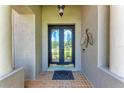 Close up of the front door featuring decorative glass and sidelights, creating a grand entrance to the home at 740 Tanager Rd, Venice, FL 34293