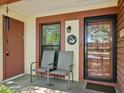Welcoming front porch with neutral chairs, a welcome sign and a peek through the front door at 7515 Greystone Dr, Hudson, FL 34667