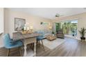 Open floor plan with dining and living area featuring water views and access to balcony at 8403 Placida Rd # 205, Placida, FL 33946