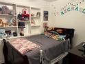 A bedroom with wall decor and built-in shelves for storage at 8629 Aero Ave, North Port, FL 34287