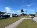 A quiet neighborhood street with well-maintained lawns and sidewalks at 8629 Aero Ave, North Port, FL 34287