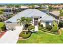 Beautiful single-story home with mature palm trees and lush landscaping in a desirable community at 863 Macaw Cir, Venice, FL 34285
