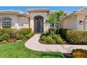 Inviting home entrance with a beautiful walkway and manicured greenery at 867 Macaw Cir, Venice, FL 34285