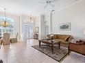 Bright living room with high ceilings, tile flooring, and elegant furnishings at 867 Macaw Cir, Venice, FL 34285
