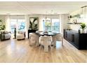 Bright dining area with stylish decor, modern light fixture, and large windows at 937 Nettuno Dr, Venice, FL 34285