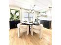 Bright dining area with stylish decor, modern light fixture, and wood-look flooring at 937 Nettuno Dr, Venice, FL 34285