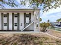 Exterior view of the property with a staircase, white and gray painted walls and partial view of the waterway at 1001 Inlet Cir # 269, Venice, FL 34285