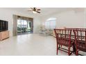 Spacious living room with tile flooring, ceiling fan, and sliding glass doors offering natural light at 1007 Gondola Park Dr # 1007, Venice, FL 34292