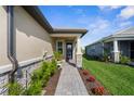 The home features a stone-accented front facade and a beautifully landscaped walkway to the front door at 11239 Boundless Ter, Venice, FL 34293