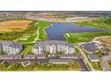 Condo complex features covered parking, lush landscaping, water views, and a nearby golf course at 12140 Wellen Golf St # 401, Venice, FL 34293