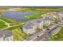 Modern condo building featuring covered parking, manicured landscaping, and water views from multiple floors at 12140 Wellen Golf St # 401, Venice, FL 34293