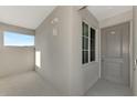 Condo entryway features a window providing natural light and a door with unit number 405 at 12140 Wellen Golf St # 401, Venice, FL 34293