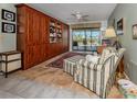 Office with built-in shelves, ceiling fan, and sliding glass doors to pool at 1229 Waterside Ln, Venice, FL 34285