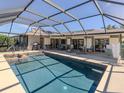 Relax in this screened pool, with attached spa, and lots of patio space for entertaining at 1229 Waterside Ln, Venice, FL 34285