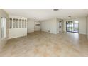Spacious living area with tile flooring, bright natural light, and an open layout at 1234 Pinebrook Way, Venice, FL 34285