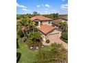 Two-story home with a tile roof, manicured landscaping, and a two car garage at 1254 Cielo Ct, North Venice, FL 34275