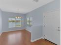 Bright dining room featuring laminate floors and a serene lake view at 12983 Tigers Eye Dr, Venice, FL 34292