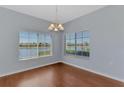 Bright dining room with laminate floors and a picturesque lake view at 12983 Tigers Eye Dr, Venice, FL 34292