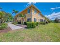 Spacious two-story home with a well-manicured lawn and lush landscaping at 12983 Tigers Eye Dr, Venice, FL 34292