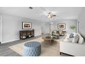 Open living room with hard surface floors, ceiling fan, and furniture at 131 Sandstone Cir, Venice, FL 34293