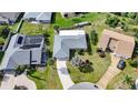 Aerial view of a well-maintained house showcasing its roof, landscaping, driveway, and neighborhood at 1311 Pine Needle Rd, Venice, FL 34285