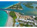 Breathtaking aerial view of waterfront homes, beach, and the Gulf of Mexico at 1555 Tarpon Center Dr # 156, Venice, FL 34285