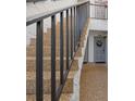 Charming stairs leading to condo units with decorative front door wreath and flower boxes at 1555 Tarpon Center Dr # 156, Venice, FL 34285