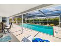 Inviting screened-in pool area with clear blue water, seating, and well-maintained deck for outdoor relaxation at 1585 Keyway Ct, Englewood, FL 34223