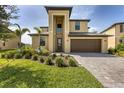 Charming two-story home with a well-manicured front yard and a two-car garage at 1951 E Isles Rd, Port Charlotte, FL 33953