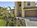 Inviting front exterior showcasing landscaped beds, stone driveway and a two-car garage at 1951 E Isles Rd, Port Charlotte, FL 33953