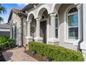 Close up of the entryway showcasing stone and a brick walkway at 19825 Bridgetown Loop, Venice, FL 34293