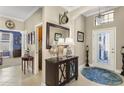 Grand foyer with a chandelier, large mirror, and decorative accents, creating an inviting entrance at 20479 Pezzana Dr, Venice, FL 34292