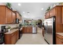 Spacious kitchen featuring wooden cabinets, granite countertops, and stainless steel appliances at 20479 Pezzana Dr, Venice, FL 34292