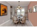 Elegant dining room featuring a round table with seating for six, modern chandelier, and stylish decor at 208 Corelli Dr, Nokomis, FL 34275