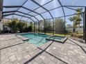 Inviting screened-in pool with a spa and spacious deck offers a private outdoor retreat at 208 Corelli Dr, Nokomis, FL 34275