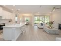 Open-concept living space featuring a spacious kitchen, dining area, and living room with plenty of natural light at 288 Soliera St, Nokomis, FL 34275