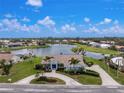 Expansive aerial view of a waterfront home showcasing the tiled roof, and lush landscaping at 351 Eden Dr, Englewood, FL 34223