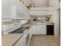 Well-maintained kitchen features modern appliances, ample counter space, and a view into the living area at 432 Sunset Lake Blvd # 205, Venice, FL 34292