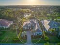 Sprawling property with lush landscaping, a serene pond, and a beautiful home, offering an oasis of tranquility at 48 Grande Fairway, Englewood, FL 34223