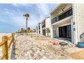 Condo complex highlighting the private balconies and beach access along a charming wooden fence at 500 Park S Blvd # 62, Venice, FL 34285