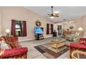 Spacious living room featuring vaulted ceilings, comfortable seating, and natural light at 500 Wekiva River Ct # 129, Englewood, FL 34223