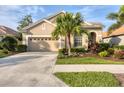 Inviting single-story home with a well-manicured lawn and a classic garage, showcasing its curb appeal at 5223 Pine Shadow Ln, North Port, FL 34287