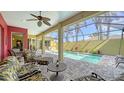 Relaxing screened-in lanai featuring a private pool, comfortable seating, and lush tropical landscaping at 525 Cheval Dr, Venice, FL 34292