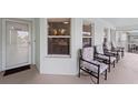 Welcoming porch featuring comfortable seating, an updated paint scheme and a screen door at 5725 Greenwood Ave # 1201, North Port, FL 34287