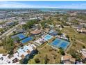 Panoramic aerial view displays the property's proximity to amenities, ocean, tennis courts, pool, and lush landscaping at 612 Bird Bay S Dr # 311, Venice, FL 34285