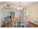 Cozy dining area with wood floors, a round table with chairs, and plenty of natural light at 612 Bird Bay S Dr # 311, Venice, FL 34285