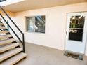 Exterior view of unit entrance with small stairs, window, and 'Home' welcome mat at 616 Guild Dr # 2, Venice, FL 34285