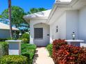 Inviting home entrance with landscaped walkway and manicured shrubs at 643 Crossfield Cir # 13, Venice, FL 34293