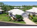 Beautiful white single-story home with lush landscaping and a well-manicured lawn at 643 Crossfield Cir # 13, Venice, FL 34293